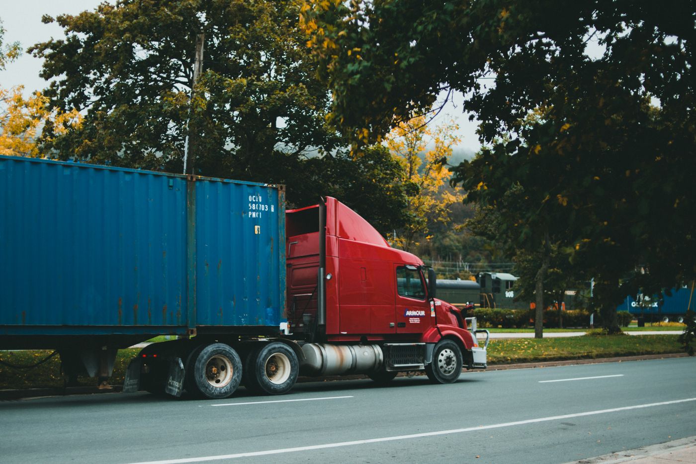Container truck travelling on a scenic road